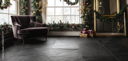 A dark stone floor with matte finish, matched with a velvet lounge chair, brass-framed mirror, and festive garlands hanging from the windows. photo