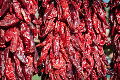 Close up of a hanging red chili pepper ristra in a public market of New Mexico, USA.