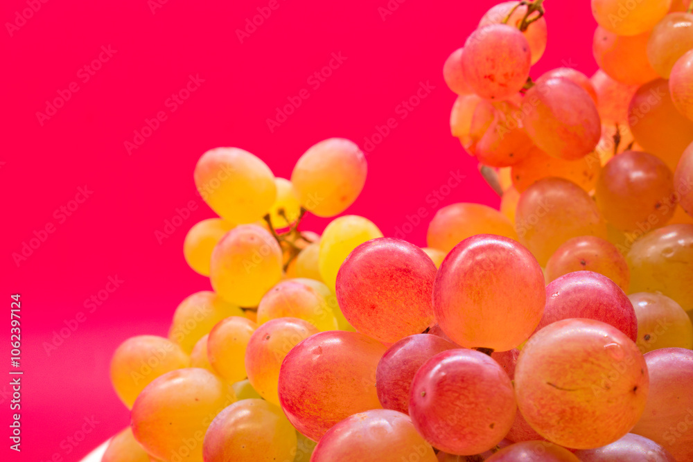Kishmish (sultana) grapes on a red background