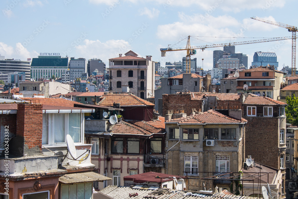 Fototapeta premium ISTANBUL, TURKEY - August 12, 2024: Panoramic view of the tall buildings of the city on a sunny summer day