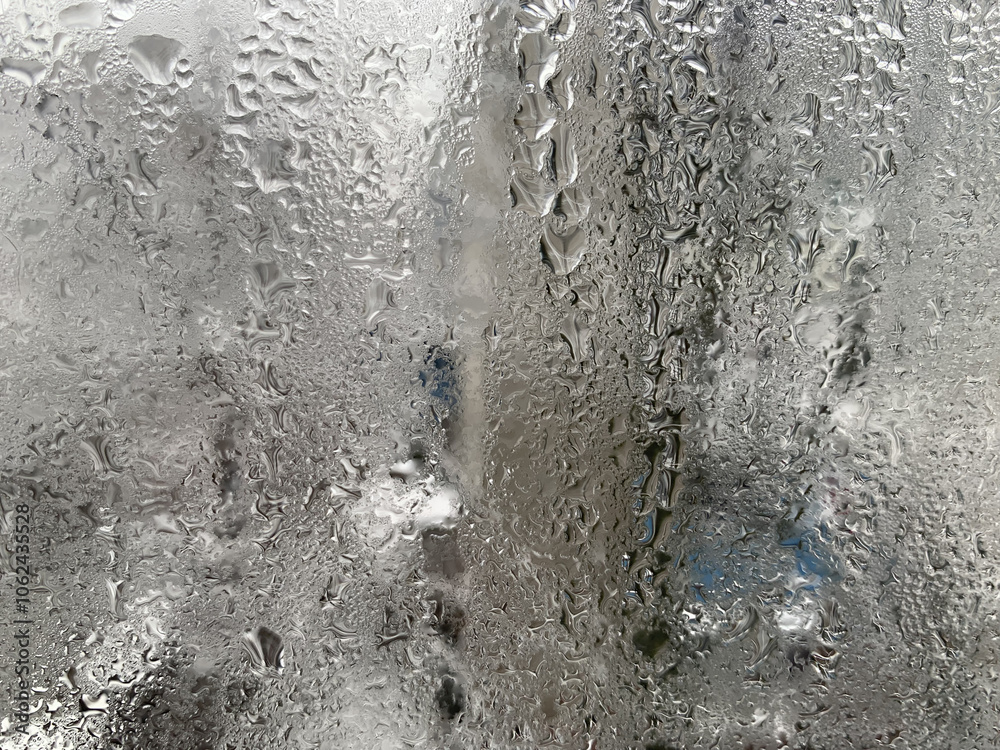 Condensation drops on the windows. Structure of wet glass in winter. Water drops on the glass surface. Texture. Problems of apartments and houses. How to solve Condensation drops on the windows. Structure of wet glass in winter. Water drops on the glass surface. Texture. Problems of apartments and houses. How to solve
