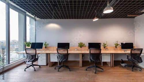 Cozy office coworking interior with pc computers in row, window. Mockup wall