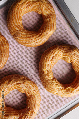 cream puff rings on a baking sheet