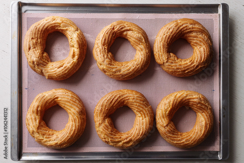 cream puff rings on a baking sheet