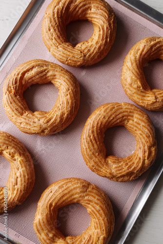 cream puff rings on a baking sheet