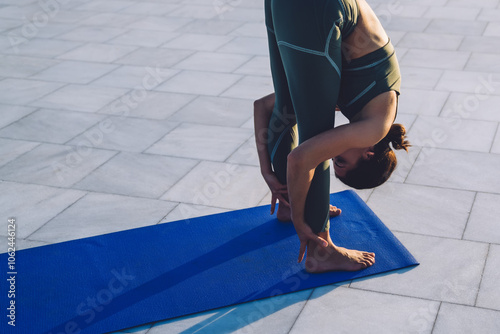 Athletic brunette stretching and meditating on fitness mat photo