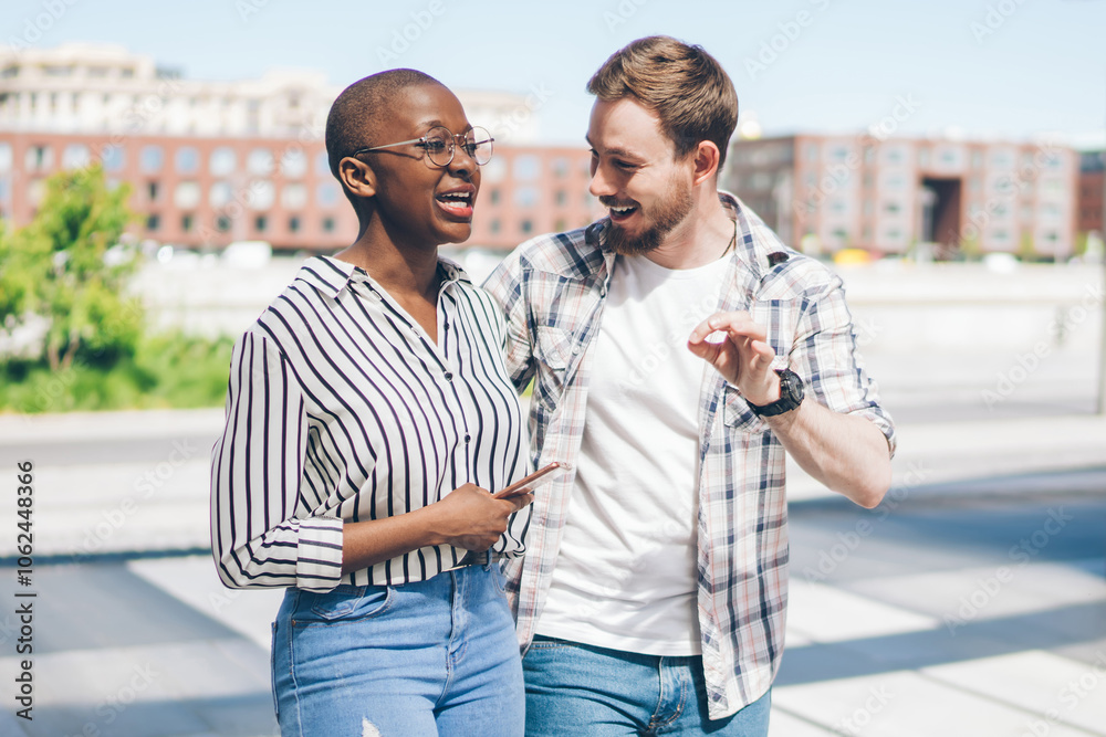 Happy diverse couple of friends enjoying walking in street Happy diverse couple of friends enjoying walking in street