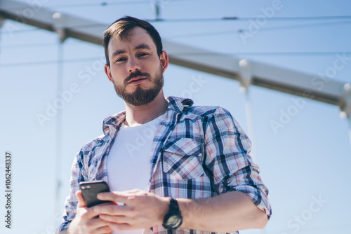 Man on bridge using mobile phone