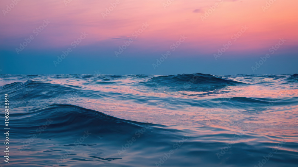 Obraz premium A serene twilight ocean scene with gentle waves, featuring a tranquil color palette of deep blues and soft pinks, creating a calming atmosphere.