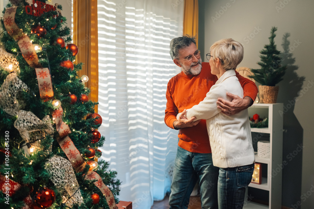 Senior couple dancing in front of christmas tree Senior couple dancing in front of christmas tree