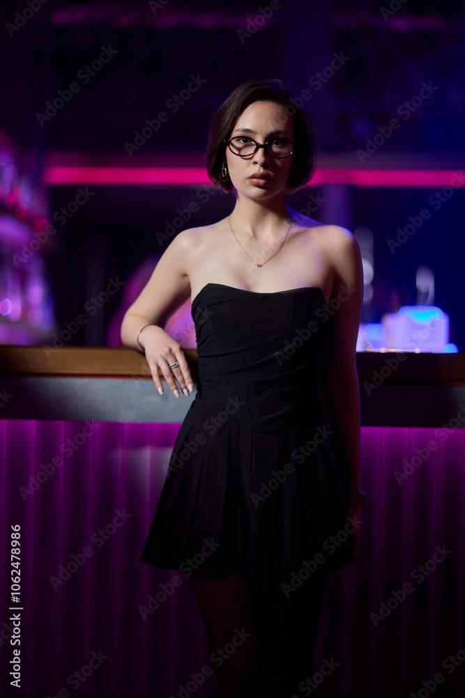 A stylish woman struts into the bar at night, exuding elegance and seduction of nightlife A stylish woman struts into the bar at night, exuding elegance and seduction of nightlife