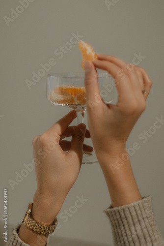 person hands with glass of tangerines
