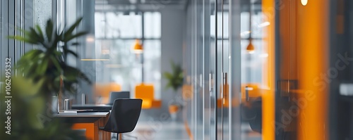 Blurred background of a modern office interior in gray tones, featuring large windows and orange accents. photo