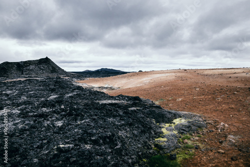 Special contrast between black vulcanic rocks from a recent erruption to brownish red soil without plants