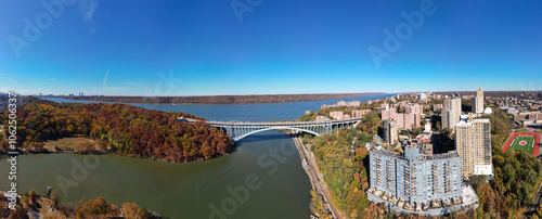 This location in the Bronx offers stunning views of lush greenery, a picturesque lake, and urban structures. Framed by the river, it showcases iconic bridges and the New York City skyline 