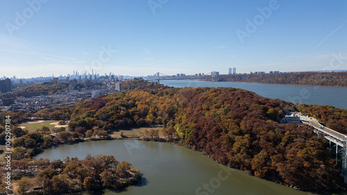 This location in the Bronx offers stunning views of lush greenery, a picturesque lake, and urban structures. Framed by the river, it showcases iconic bridges and the New York City skyline 