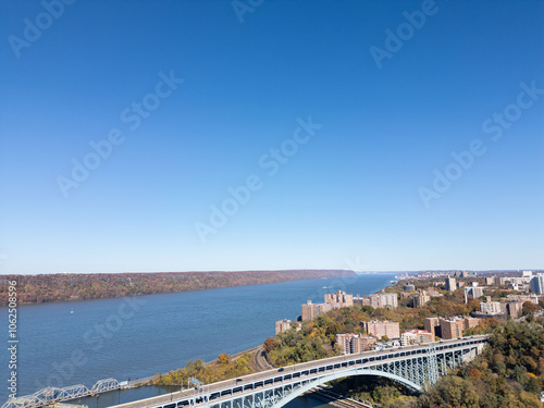 This location in the Bronx offers stunning views of lush greenery, a picturesque lake, and urban structures. Framed by the river, it showcases iconic bridges and the New York City skyline 