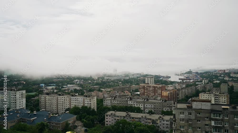 The fog descends from the mountains by the sea and covers the city on the shore. Cool timelapse of a natural phenomenon The fog descends from the mountains by the sea and covers the city on the shore. Cool timelapse of a natural phenomenon