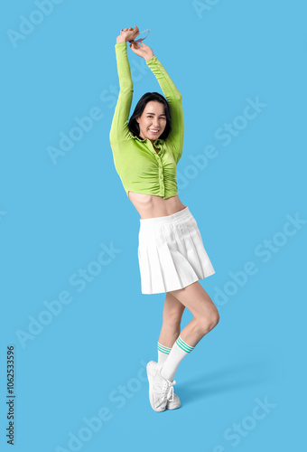 Happy young woman dancing o...