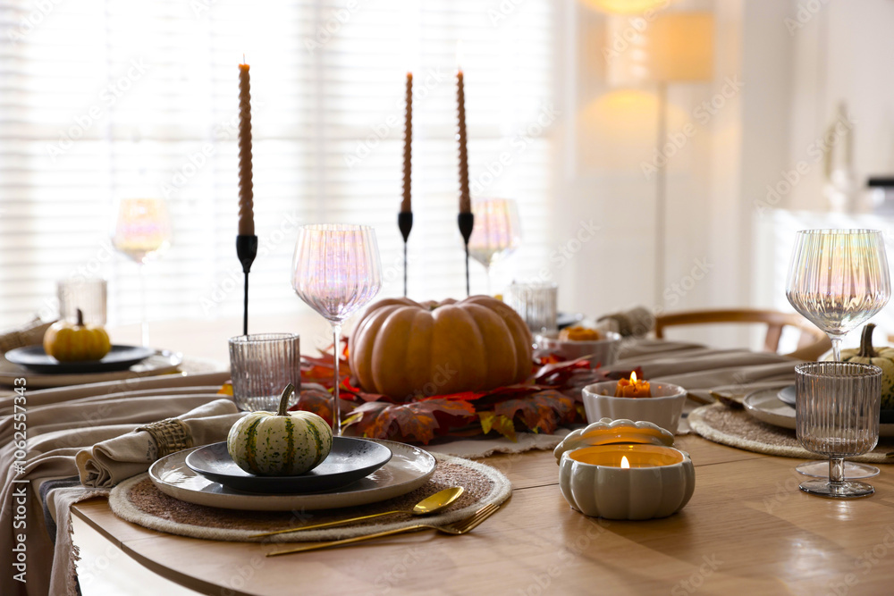 Naklejka premium Stylish table setting with beautiful dishware and autumn decor in dining room