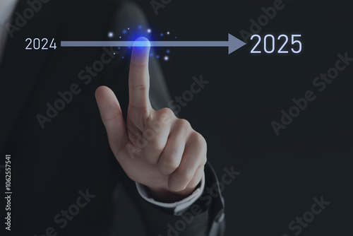 New year goals. Businessman touching arrow leading from 2024 to 2025 on virtual screen against black background, closeup