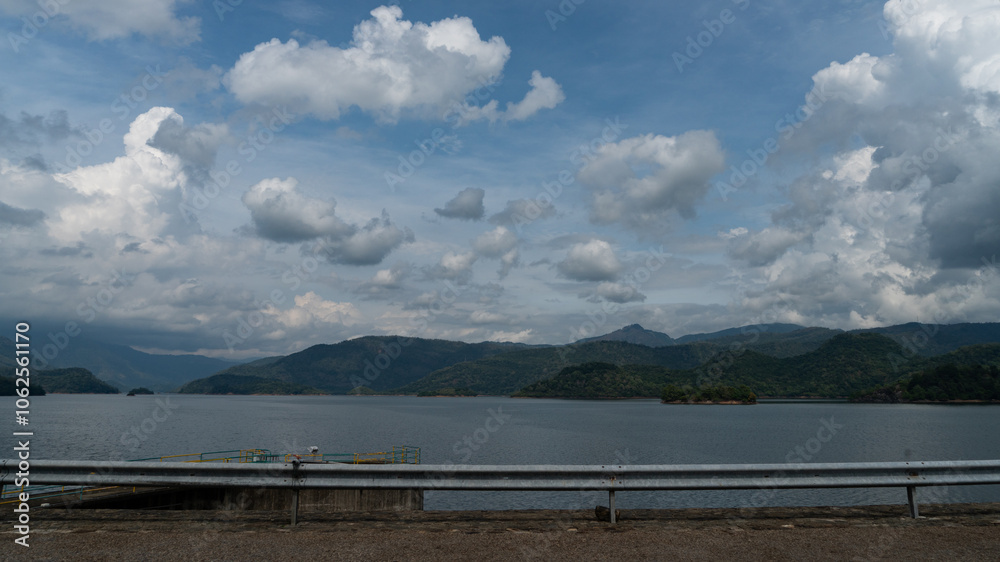 panoramic landscape view of clouds and forest reflecting on the water
