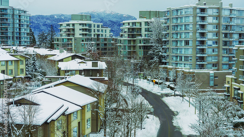 BC suburban residential development on a snowy winter day with mountain backdrop.