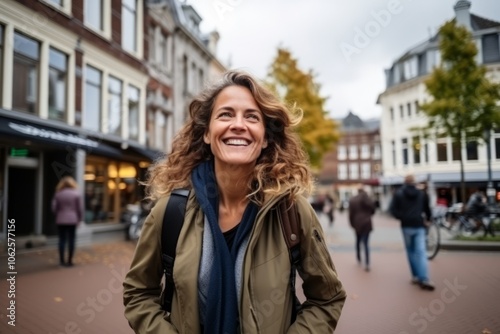Portrait of a beautiful young woman smiling in the street in Amsterdam