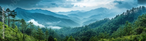 Stunning Panoramic View of Misty Mountain Range with Lush Green Forests and Dramatic Sky in Serene Landscape