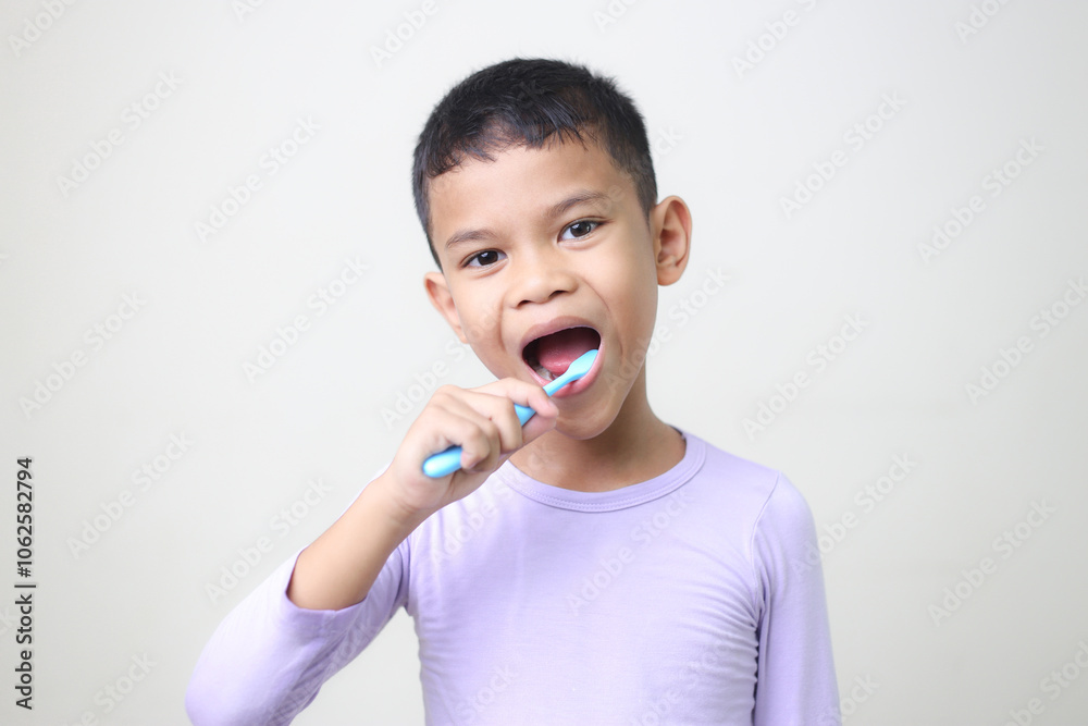 child Asia kid boy brushing teeth isolated on white backgroud. child Asia kid boy brushing teeth isolated on white backgroud.