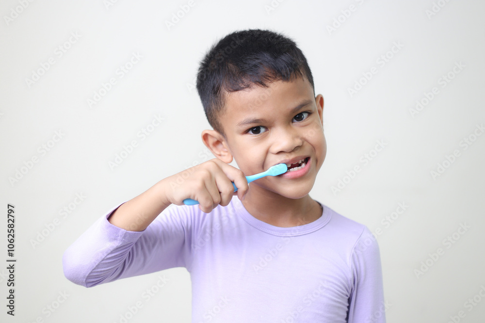 child Asia kid boy brushing teeth isolated on white backgroud. child Asia kid boy brushing teeth isolated on white backgroud.