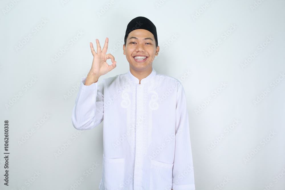 smiling asian man muslim show ok signs isolated on white background smiling asian man muslim show ok signs isolated on white background