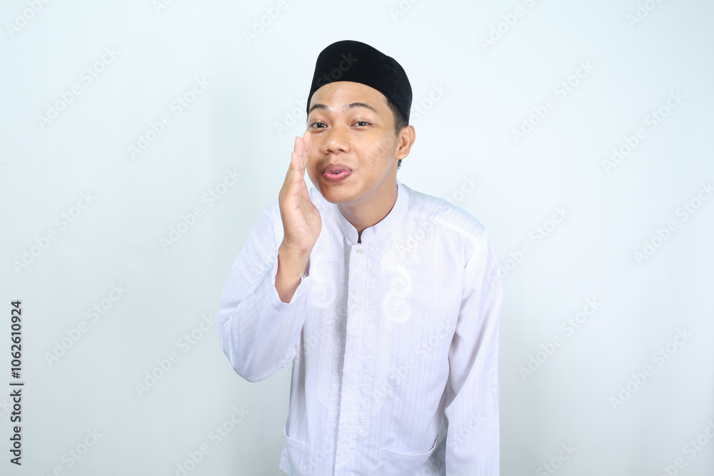happy asian muslim man whispering something at camera isolated on white background happy asian muslim man whispering something at camera isolated on white background