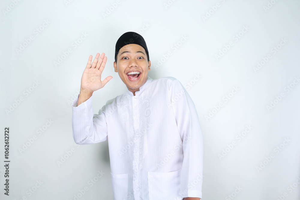 funny asian muslim man show surprised expression while waving hand say hello isolated on white background funny asian muslim man show surprised expression while waving hand say hello isolated on white background