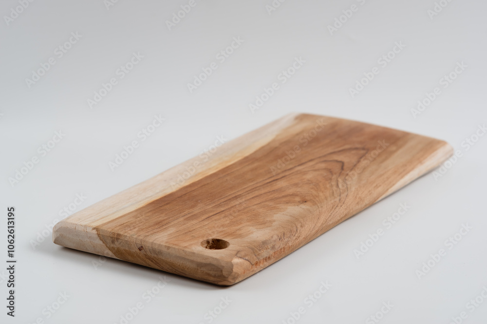 Food preparation tool and kitchen utensils concept with close-up on rectangular wood chopping board with round corners isolated on white background at an angle perspective with clipping path cutout Food preparation tool and kitchen utensils concept with close-up on rectangular wood chopping board with round corners isolated on white background at an angle perspective with clipping path cutout