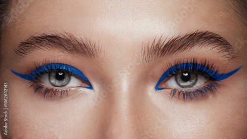 Electric Blue Mascara, Bold Minimalism: A front-facing close-up of both eyes, where each lash is coated in vibrant electric blue mascara, standing out strikingly against natural, makeup-free skin