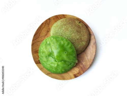 Serabi hijau or Indonesian traditional cake made from rice flour mixed coconut palm sugar isolated on white background  photo