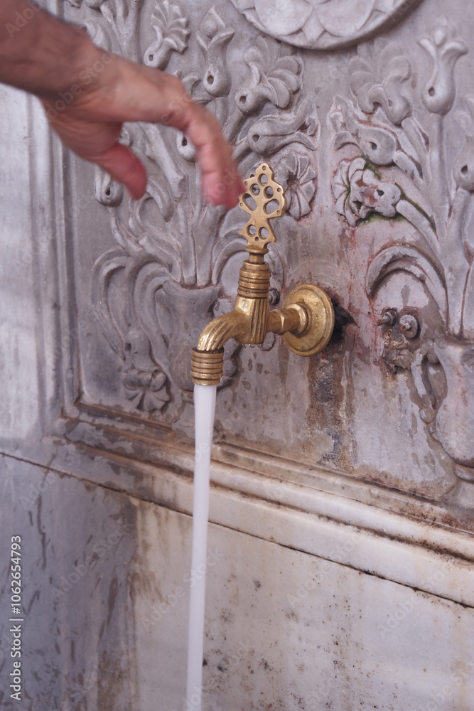 This is a beautiful antique water faucet featuring a delightful flow of refreshing water This is a beautiful antique water faucet featuring a delightful flow of refreshing water