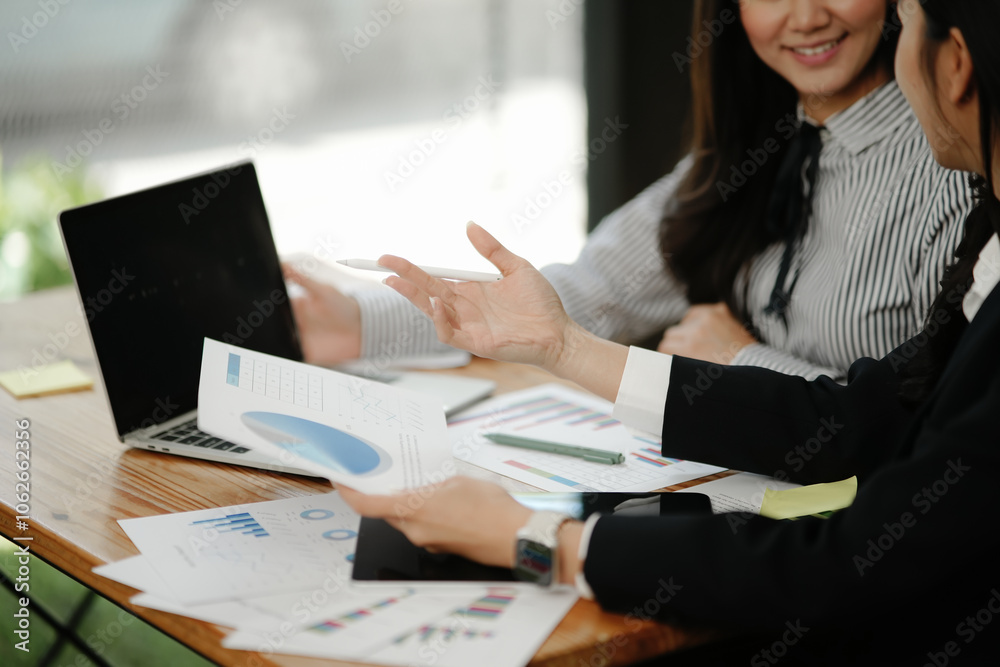 Asian business woman working and talking at the office
Asian business woman working and talking at the office