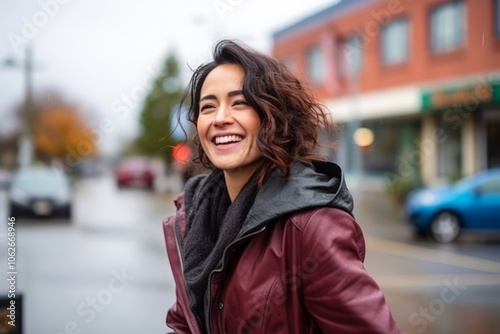 Portrait of a beautiful young woman smiling in a city street.