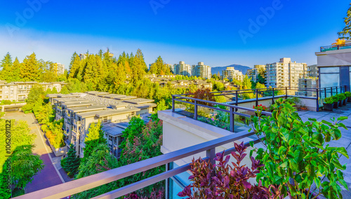 Cityscape of the residential suburb of UniverCity Highlands, Burnaby, BC, as seen from a neighborhood patio.