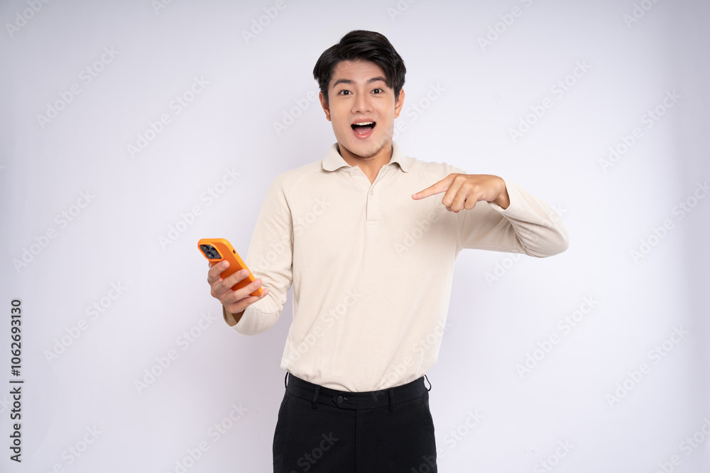 Portrait of young asian businessman wearing sweater and using phone on white background