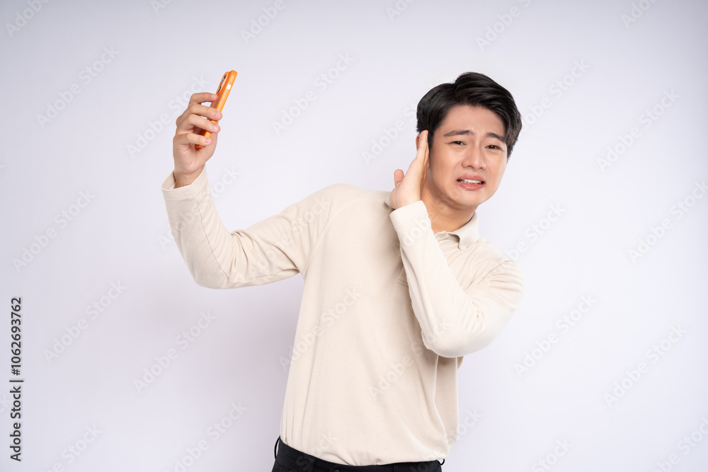 Portrait of young asian businessman wearing sweater and using phone on white background Portrait of young asian businessman wearing sweater and using phone on white background