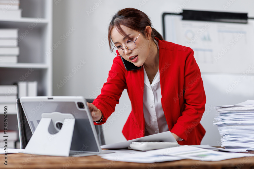 Asian busty employee, Young asian business woman holding paper while working and talking phone at office table, Happy office girl working, business people casual lifestyle Asian busty employee, Young asian business woman holding paper while working and talking phone at office table, Happy office girl working, business people casual lifestyle