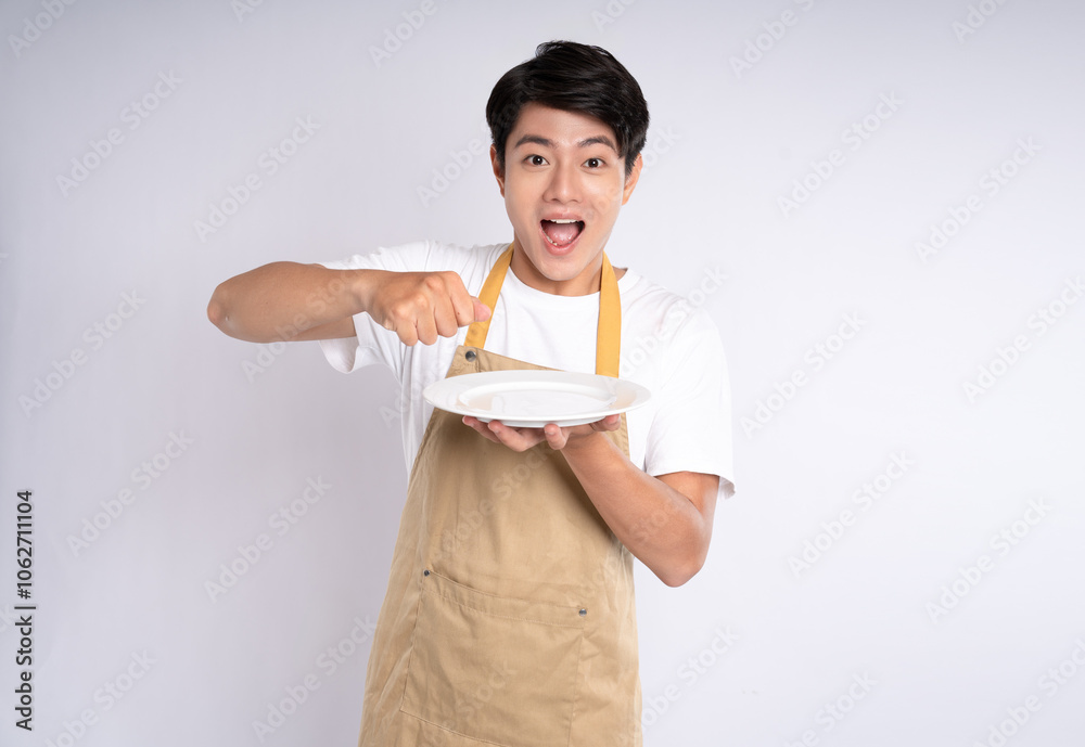 Portrait of young asian man wearing apron and posing on white background Portrait of young asian man wearing apron and posing on white background