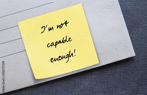 Office envelope with text written on stick note - I am not capable enough - Self-doubt - lack of confidence regarding oneself and abilities - feeling insecurity, awareness of one own limitations