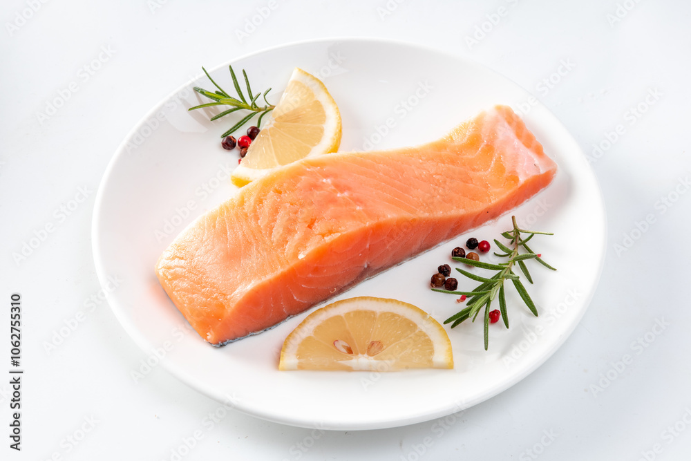 Juicy slice of fresh salmon with ingredients closeup isolated on a white background Juicy slice of fresh salmon with ingredients closeup isolated on a white background