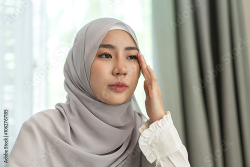 Young muslim woman in hijab experiencing stress and fatigue, headache, expressing emotions, mental health concept, sick, psychological wellbeing, personal reflection, diseased and migraine