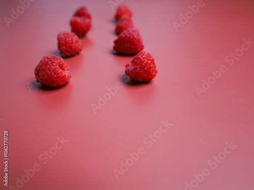 Two lines of fresh raspberry at the red background photo