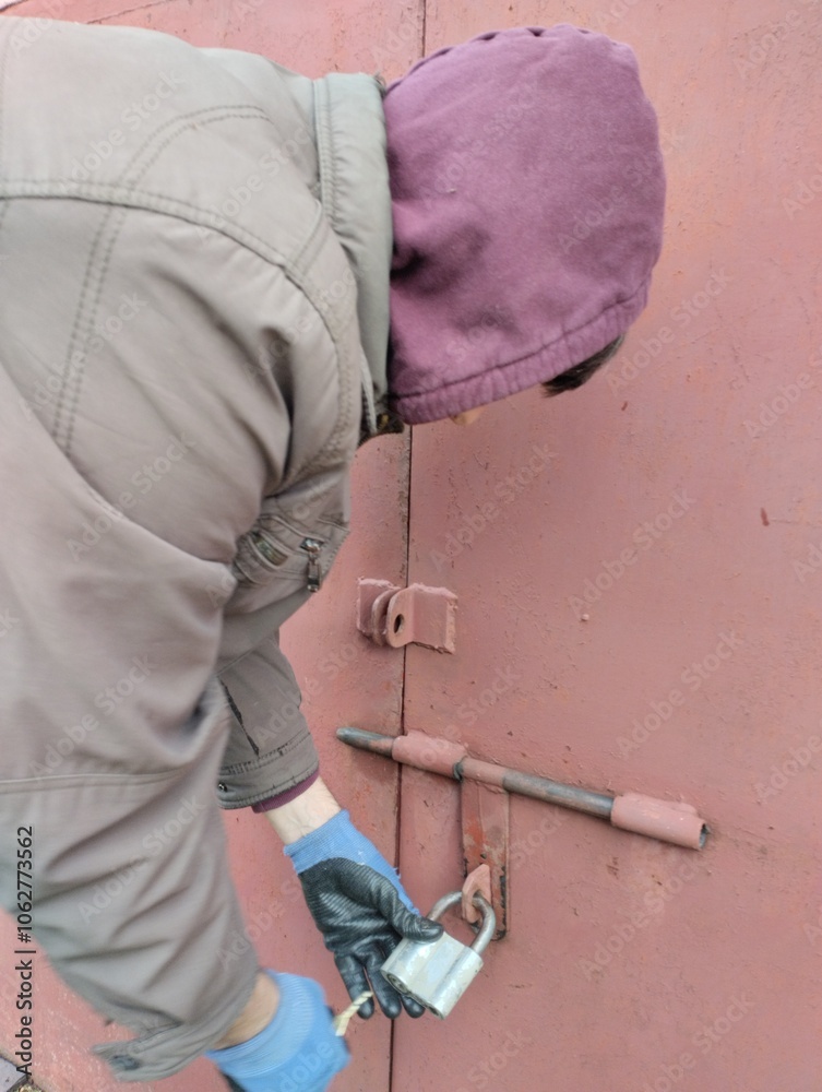 burglar, thief trying to open the lock, thief robs house